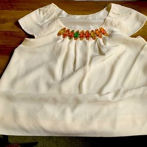 Cap sleeved, gem stone neckline top. Flowy and tucks in nicely.